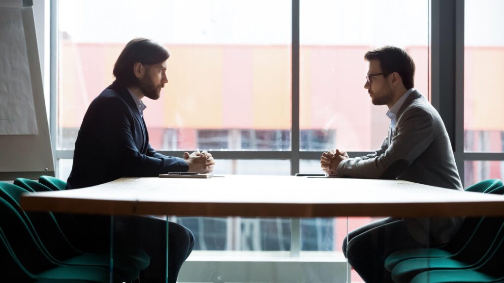 Two professionals negotiating a cannabis real estate transaction