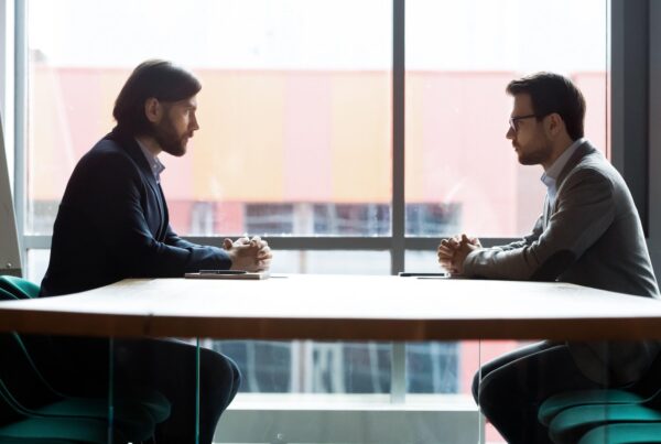 Two professionals negotiating a cannabis real estate transaction